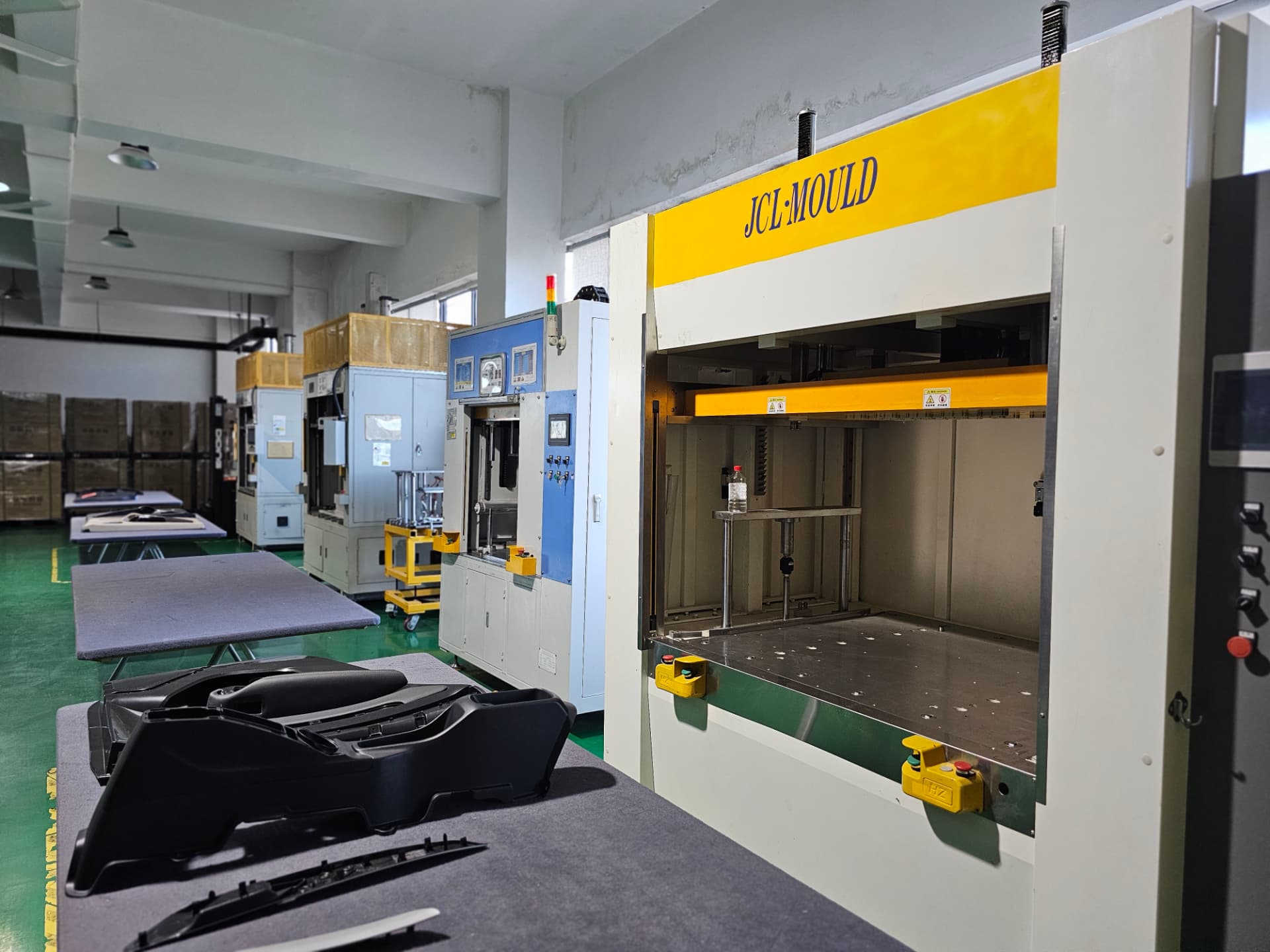 Row of assembly presses with moulded interior trim parts staged for build